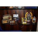 A COLLECTION OF VINTAGE RADIOS, A JUKE BOX RADIO AND MONEY BANKS ETC (9)