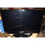 A SAMSUNG 40 INCH FLAT SCREEN TV WITH REMOTE AND INSTRUCTIONS