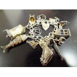 A STERLING SILVER CHARM BRACELET, APPROX TOTAL WEIGHT 63.3G