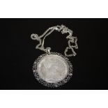 A COIN PENDANT ON SILVER CHAIN