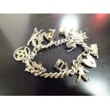 A STERLING SILVER CHARM BRACELET, APPROX TOTAL WEIGHT 55.5G