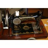 A FRISTER AND ROTHMAN CASED SEWING MACHINE