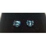 A PAIR OF LONDON BLUE TOPAZ STUDS, BOXED