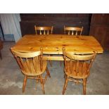 A SOLID PINE DINING TABLE AND FOUR CHAIRS