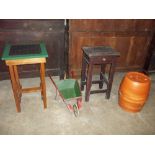 TWO TABLES, A DECORATIVE GARDEN WHEELBARROW AND A POTTERY BARREL PLANT STAND