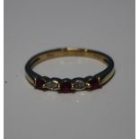 A 9 CT YELLOW GOLD FIVE STONE RUBY AND DIAMOND RING