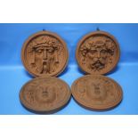 FOUR TERRACOTTA CLASSICAL STYLE HANGING FACE PLAQUES