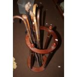 A STICK STAND AND A COLLECTION OF WALKING STICKS