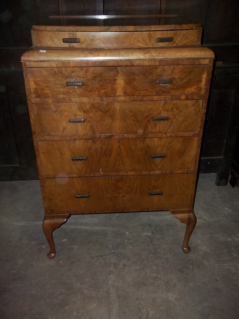 A BURR WALNUT BRITISH MADE FIVE DRAW PARTIALLY BOW FRONTED CHEST OF DRAWS WITH CABREOLE LEGS