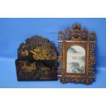 AN ORIENTAL STYLE FRAME TOGETHER WITH AN ORIENTAL STYLE PAPIER MACHE LETTER RACK