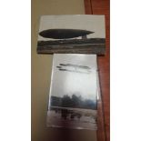 A GLASS PAPERWEIGHT OR PICTURE FRAME INCLUDING A POSTCARD OF THE FIRST WORLD WAR AIRSHIP "THE