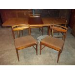 A TEAK EXTENDING TABLE AND FOUR CHAIRS BY MCINTOSH