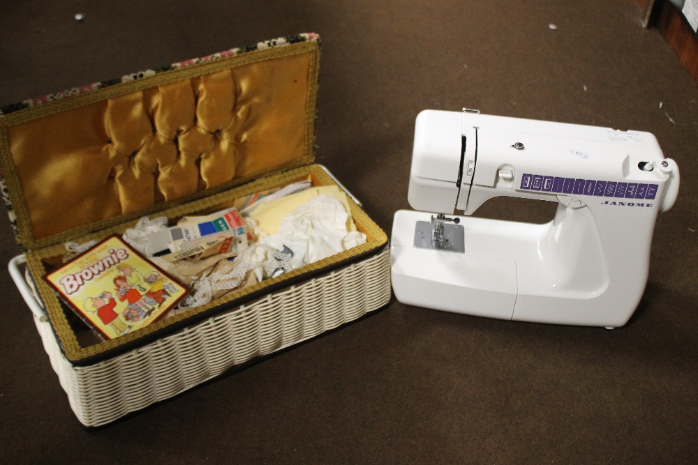 A JANOME SEWING MACHINE AND A SMALL QUANTITY OF SEWING ACCESSORIES