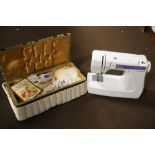 A JANOME SEWING MACHINE AND A SMALL QUANTITY OF SEWING ACCESSORIES