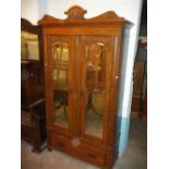 AN ANTIQUE OAK WARDROBE