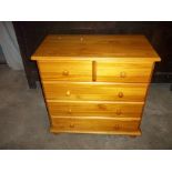 A SOLID PINE THREE DRAW CHEST OF DRAWS, TWO OVER THREE