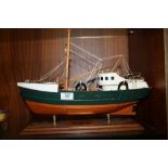 A HAND BUILT WOODEN MODEL OF A TRAWLER ON STAND