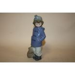 A NAO FIGURE OF A YOUNG BOY WITH A SATCHEL