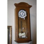 A MODERN HERMLE WALL CLOCK WITH KEY