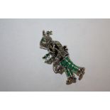 A STERLING SILVER PLIQUE DE JOUR BROOCH IN THE FORM OF A RABBIT CARRYING FOOD AND DRINKS