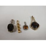 FOUR SILVER AND SILVER GILT VINTAGE PENDANTS, TO INCLUDE CITRINE, TWO LARGE SMOKEY QUARTZ ETC. (4)
