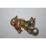 A STERLING SILVER PLIQUE DE JOUR BROOCH IN THE FORM OF A CAT WITH A BALL