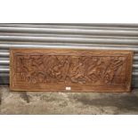 A LARGE TRIBAL STYLE CARVED HARD WOOD PANEL, 102 X 36 CM