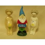 A PAIR OF NOVELTY NUDE CERAMIC FIGURES TOGETHER WITH A GARDEN GNOME