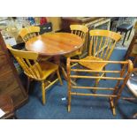 A HONEY PINE CIRCULAR PEDESTAL TABLE, 4 CHAIRS AND A TOWEL RAIL