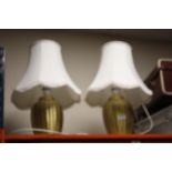 A PAIR OF GOLD TABLE LAMPS WITH SHADES