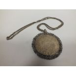 A COIN PENDANT ON SILVER CHAIN