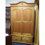 A HONEY PINE DOUBLE WARDROBE WITH 2 DRAWERS BELOW H 218 CM W 129 CM