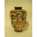 A JAPANESE CERAMIC FIGURAL VASE WITH ORNATE RELIEF