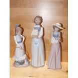 THREE NAO FIGURES COMPRISING BOY CARRYING BOOKS, A GIRL WITH A HULA HOOP AND A GIRL WITH A DOLL, ALL