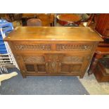 A VINTAGE CARVED OAK SIDEBOARD