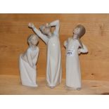 THREE LLADRO FIGURES OF CHILDREN IN GOWNS, WITHOUT MODEL NUMBERS