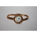 AN ANTIQUE 9 CT GOLD WRISTWATCH ON 9 CT GOLD TRAP, A/F