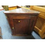 AN ANTIQUE OAK HANGING CORNER CUPBOARD