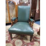 AN EDWARDIAN CARVED OAK GENTLEMANS ARMCHAIR WITH GREEN LEATHER UPHOLSTERY