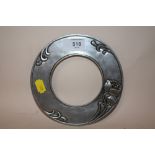 AN ART NOUVEAU PEWTER CIRCULAR PICTURE FRAME