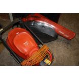 A FLYMO EASI GLIDE 300 PLUS A FLYMO GARDEN VAC 1500 PLUS