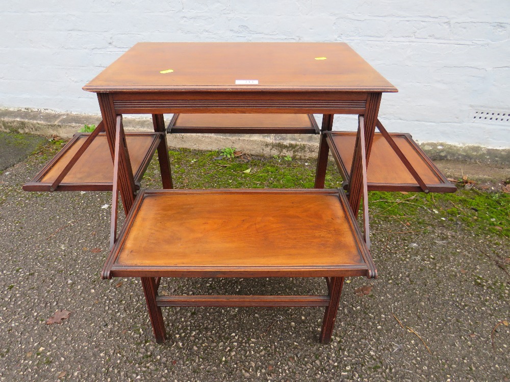 AN ARTS AND CRAFTS STYLE MAHOGANY TABLE WITH FOLD OUT SHELVES H-73 CM