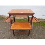 AN ARTS AND CRAFTS STYLE MAHOGANY TABLE WITH FOLD OUT SHELVES H-73 CM