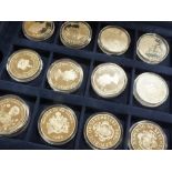 A CASED COLLECTION OF TWENTY FOUR COMMEMORATIVE SILVER COINS