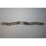 A GENT'S STERLING SILVER CURB LINK I.D. BRACELET