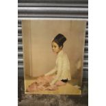 AN UNFRAMED RETRO STYLE PRINT OF A SEATED LADY