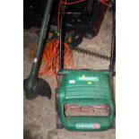 A QUALCAST CONCORDE 32 ELECTRIC LAWNMOWER TOGETHER WITH A BLACK & DECKER STRIMMER PLUS A HEDGE