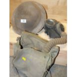 A VINTAGE MILITARY HELMET TOGETHER WITH A GAS MASK