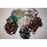 A BAG OF ASSORTED COSTUME JEWELLERY, NECKLACES ETC.