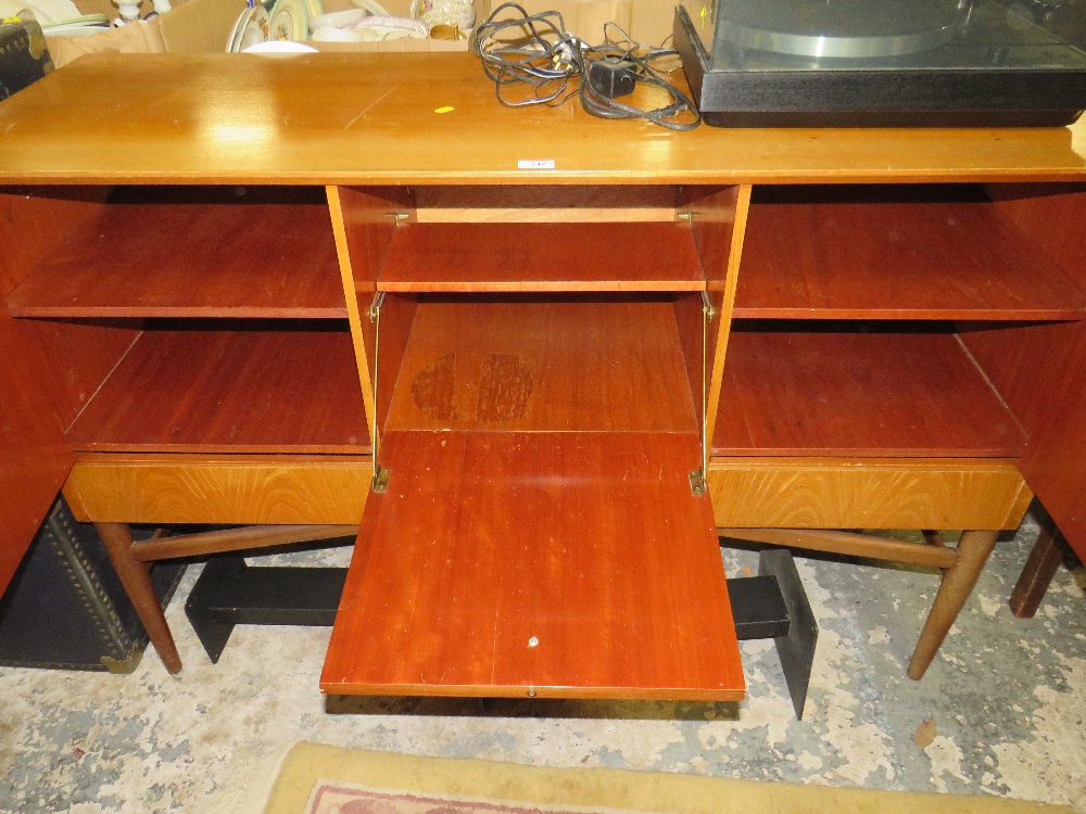 A RETRO TEAK SIDEBOARD WITH THREE CUPBOARDS ABOVE DRAWERS RAISED ON CYLINDRICAL LEGS H-94.5 W-140 - Image 2 of 2